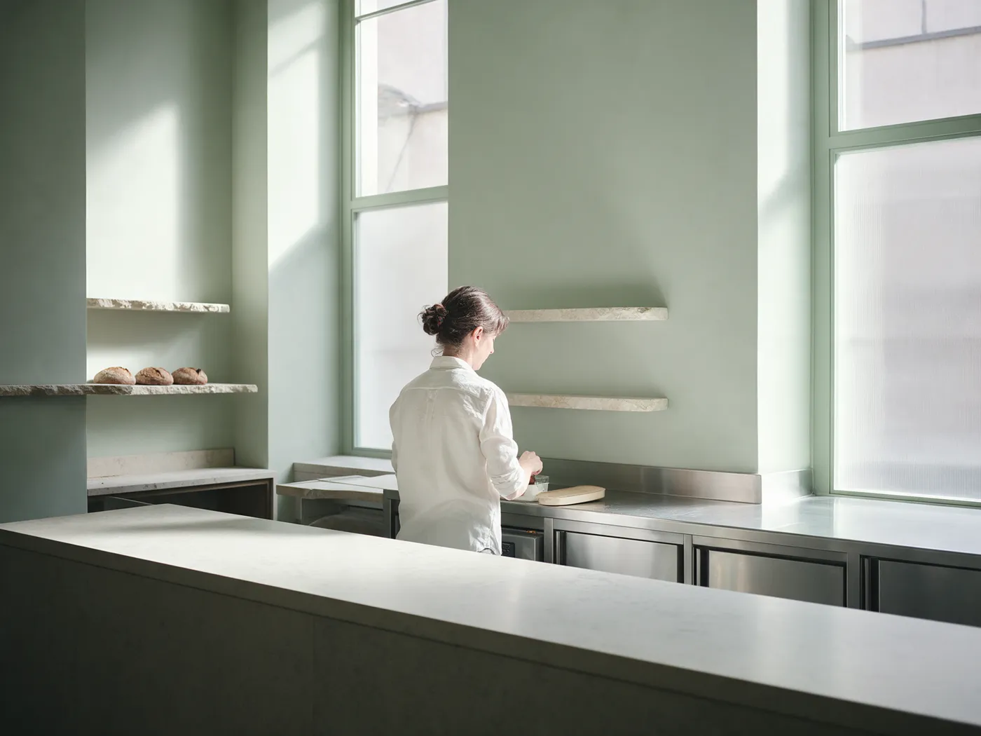 A bakery owner at her counter